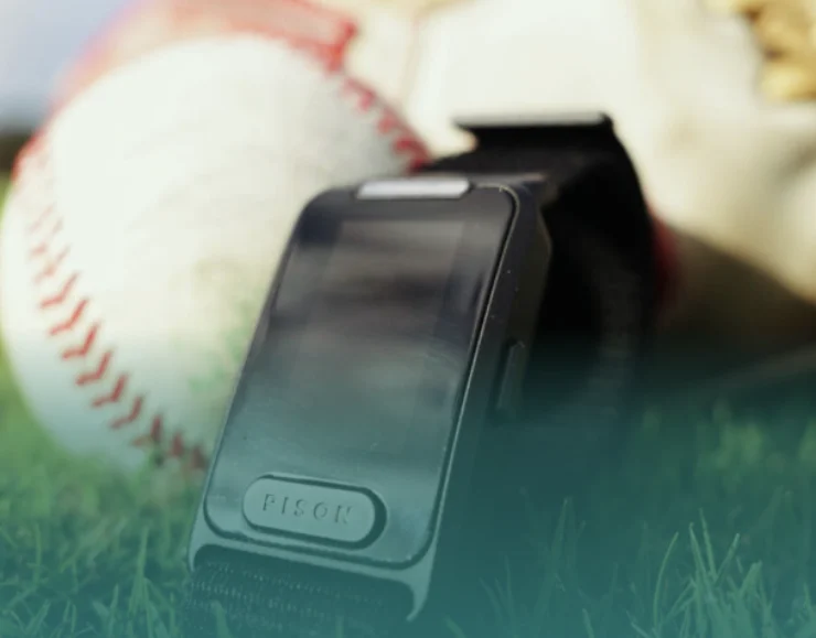 an image of the Pison baseball wearable in a field with a baseball